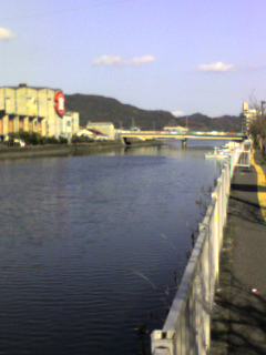 臼杵川の向こうのしょうゆみそ工場